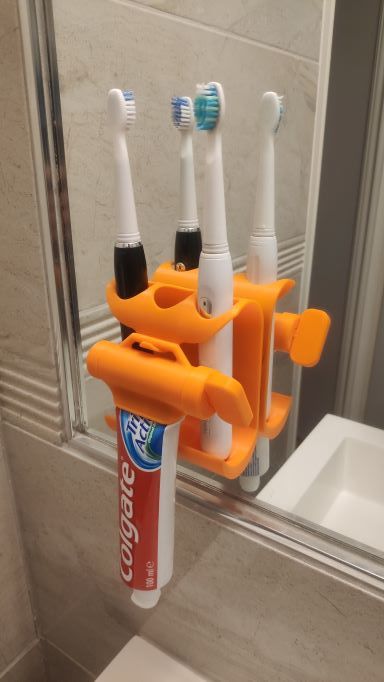 Wandhouder en tandpastaknijper voor tandenborstel